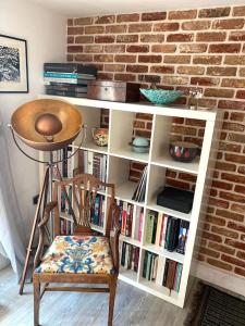 a book shelf with a chair in a room at Chapel Theatre House in Sandgate