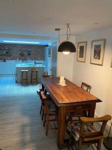 a dining room with a wooden table and chairs at Chapel Theatre House in Sandgate