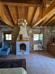 a living room with a fireplace and a blue couch at Bahab Guest House in Doğanbey