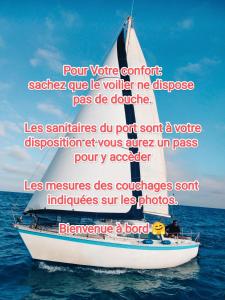a boat in the water with a quote about a boat at Nuit insolite à bord d'un voilier et sortie à la Voile au cœur de la ville de Sète in Sète