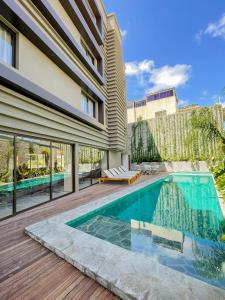 a swimming pool in the backyard of a house at Tintto Hotel in Fortaleza