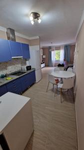 a kitchen with blue cabinets and a table and chairs at CASA LORY in Playa Blanca +23 photos