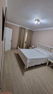 a bedroom with a large bed and a television at CASA LORY in Playa Blanca