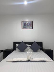 a bedroom with a bed with two swans on it at Fil's Resort in Moalboal +11 photos