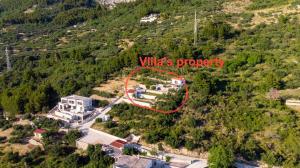 an aerial view of a house in a mountain at Olive Stone House in Makarska