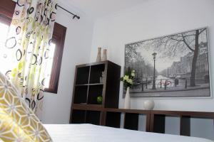 a bedroom with a bed and a picture on the wall at Casa Rural Caminito del Rey in Alora +23 photos