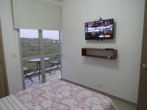 TV a/nebo společenská místnost v ubytování Espectacular y cómodo Apartamento en Girardot WiFi