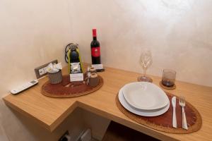 a table with a plate and a bottle of wine at POPOLO PEN 56 Apartament in Rome