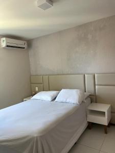 a bedroom with a large bed with white sheets at ILOA RESORT - Barra de São Miguel in Barra de São Miguel