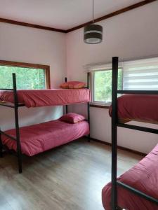 a room with three bunk beds and a window at Villarrica Pucón Aldea Molco in Villarrica