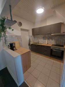 a large kitchen with brown cabinets and a counter at Ferienhaus Cissy in Lübeck