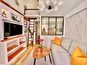 a living room with a couch and a tv at DUPLEX LE GESÙ - VIEILLE VILLE - CLIM - WIFI in Nice