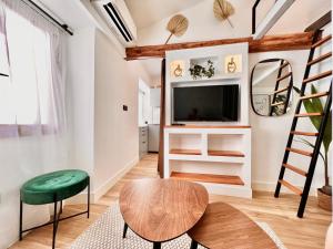 a living room with a television and a table at DUPLEX LE GESÙ - VIEILLE VILLE - CLIM - WIFI in Nice