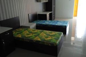 two beds sitting in a room with at Studio House Kampar in Kampar