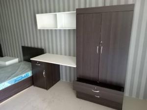 a bedroom with a bed and a wooden cabinet at Studio House Kampar in Kampar +13 photos