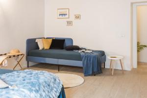 ein Wohnzimmer mit einem blauen Sofa und einem Tisch in der Unterkunft DOMUSBERGAMO - Boutique Apartment in Bergamo