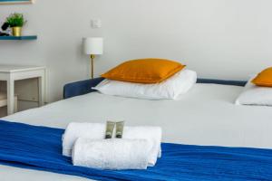 a white bed with two towels on top of it at Superb studio just nearby the Versailles palace - Welkeys in Versailles