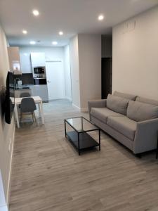 a living room with a couch and a table at Apartamentos Kai Santurtzi in Santurce