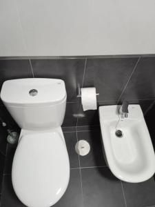 bagno con servizi igienici bianchi e lavandino di Loft nuevo a Pontevedra