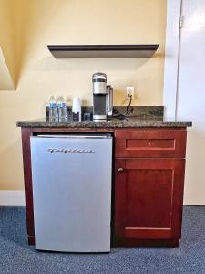 a kitchen with a sink and a refrigerator at Winthrop Arms Hotel Restaurant Logan Airport in Winthrop