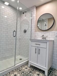 a bathroom with a shower and a sink and a mirror at Winthrop Arms Hotel Restaurant Logan Airport in Winthrop
