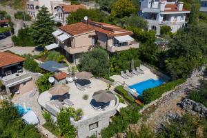 an aerial view of a house with a swimming pool at Apartments House Barbara in Kornić