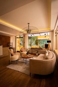 a living room with two couches and a table at Torre Dorada Cusco in Cusco