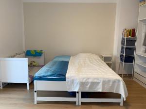 a small bedroom with a bed and a book shelf at Charming Villach Hideaway - 1BR in Villach