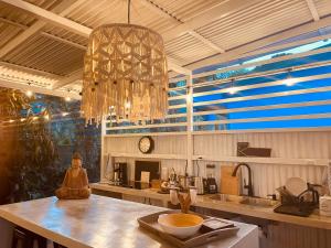 a kitchen with a chandelier hanging over a counter at Casa Luce in Puerto Viejo