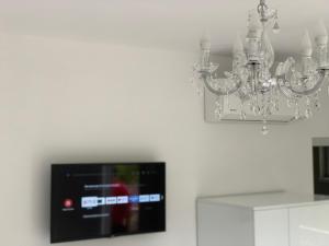 a chandelier is hanging from a white wall at Villa Perla di Mare in Kranevo +20 photos
