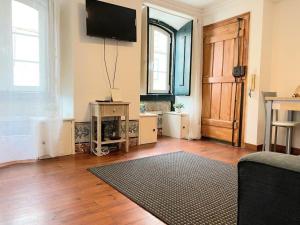 a living room with a flat screen tv on the wall at Cozy Estrela Apartment in Lisbon