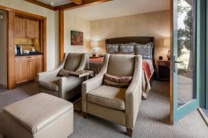 a bedroom with a bed and two chairs and a table at Sunriver Resort in Sunriver