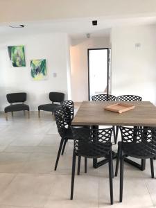 a dining room with a wooden table and chairs at La Pasionaria casa de sierras in Santa Rosa de Calamuchita