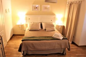 グッビオにあるRomantic Suiteのベッドルーム1室(大型ベッド1台、ランプ2つ付)