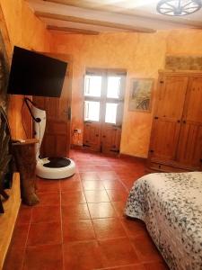 a bedroom with a bed and a lamp on a tiled floor at Casa Alba in Xert