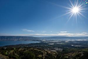 a view of a lake with the sun in the sky at Jacob Ohalo Kinneret in Kinneret