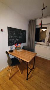 a wooden table with a chair and a chalkboard at Apart of "MET" in Mellrichstadt