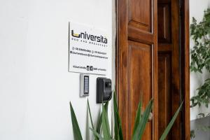 a sign on a door that reads university is not my strength at B&B Università in Naples