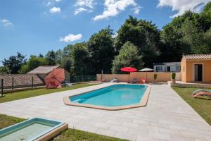 a swimming pool in the backyard of a house at Domaine de Malouziès in Fontiers-Cabardès