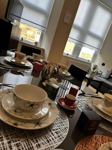 a table with plates and cups on top of it at Mamma House in Melrose