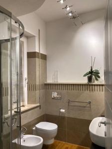 a bathroom with a toilet and a sink at Thesan Lodge, chic & modern design apartment in Grosseto