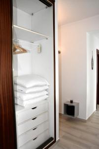 a mirror in a closet with white towels at Casa Azul in Monte Gordo