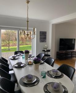 a dining room with a white table and chairs at Haus Lisa in Neustadt in Holstein