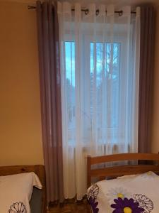 Säng eller sängar i ett rum på Apartament u Katarzyny