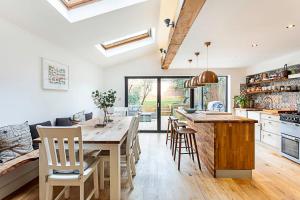 a kitchen with a large wooden table and chairs at Lovely Camberwell House in London