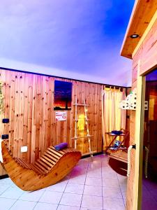 a room with a wooden wall with two wooden hammocks at Dormi nella SPA privata con letto ad acqua, sauna, doccia emozionale e kneipp in Alessandria +109 photos