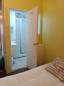 a bedroom with a door open to a bathroom at Hotel Paseo Valle in Viña del Mar