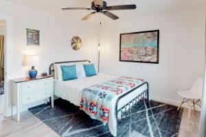 a bedroom with a bed and a ceiling fan at The Beach Sunflower in Pensacola Beach