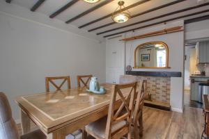 a dining room with a wooden table and chairs at Acorn Cottage in Keswick