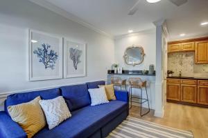 a blue couch in a living room with a kitchen at Sea La Vie in Tybee Island